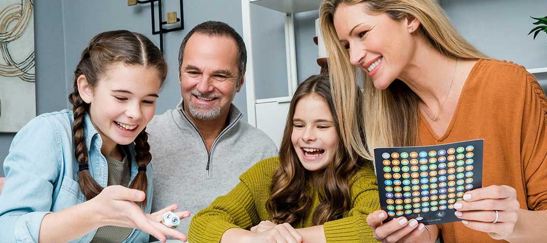 A family smiling while playing a game